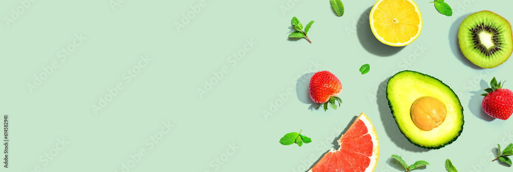 Avocado and mixed fruits overhead view flat lay