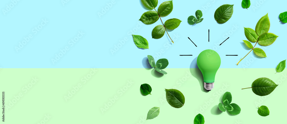 Green light bulb with green leaves - Flat lay