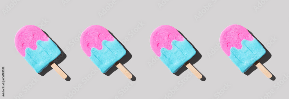 Pink and blue popsicles with shadow - flat lay