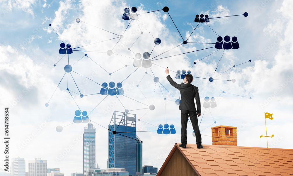 Businessman on house roof presenting networking and connection concept. Mixed media