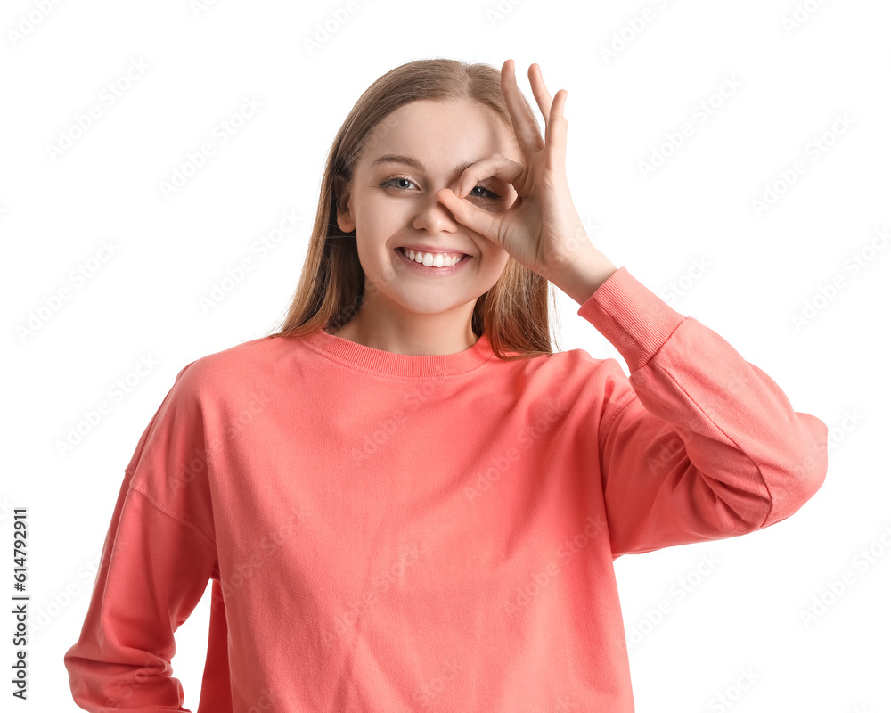 Young woman in red sweatshirt showing OK on white background