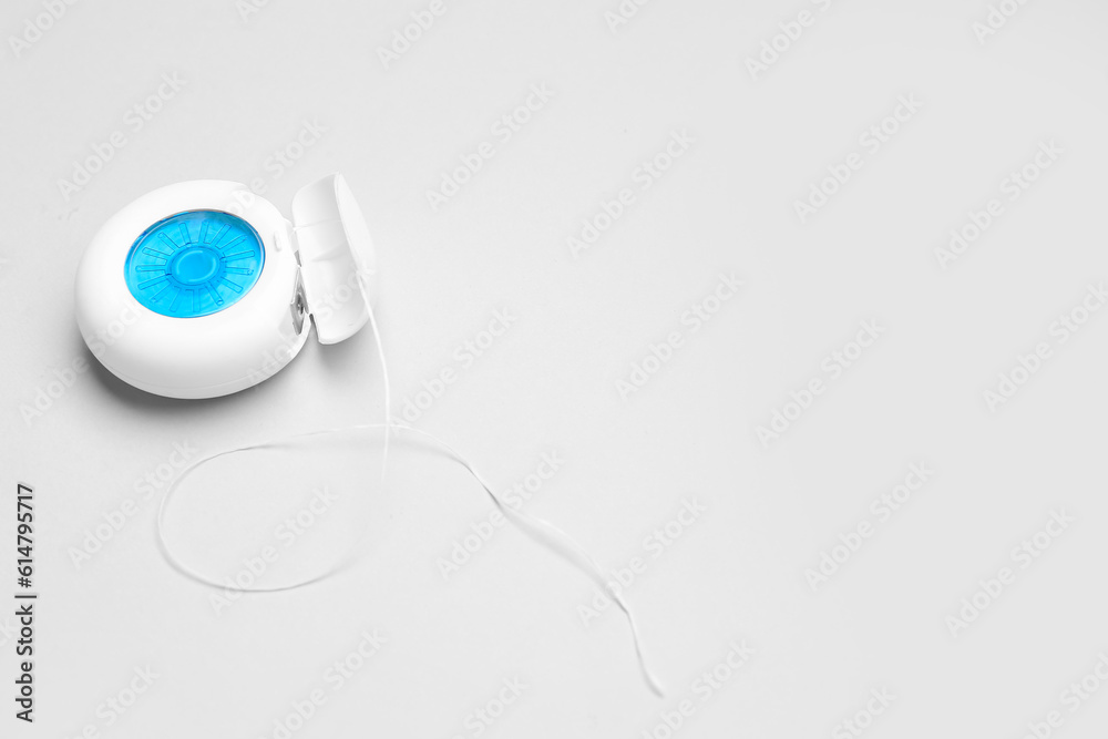 Dental floss on grey background