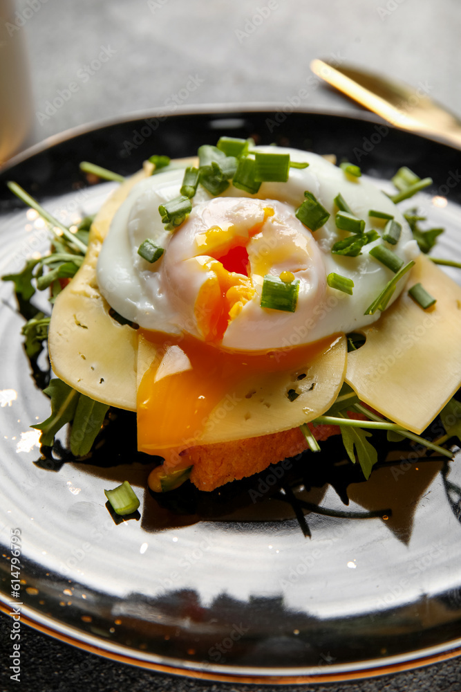 Plate with tasty egg Benedict on table, closeup