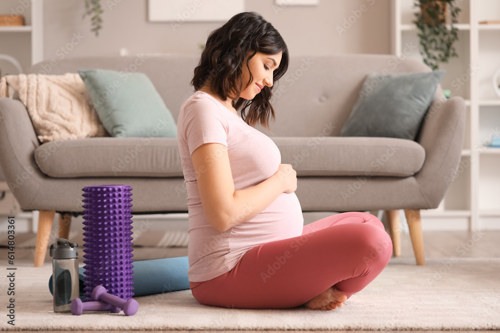 Sporty pregnant woman at home