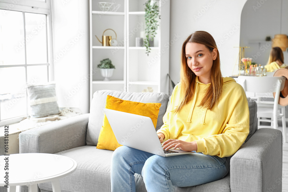 Female student studying with laptop at home