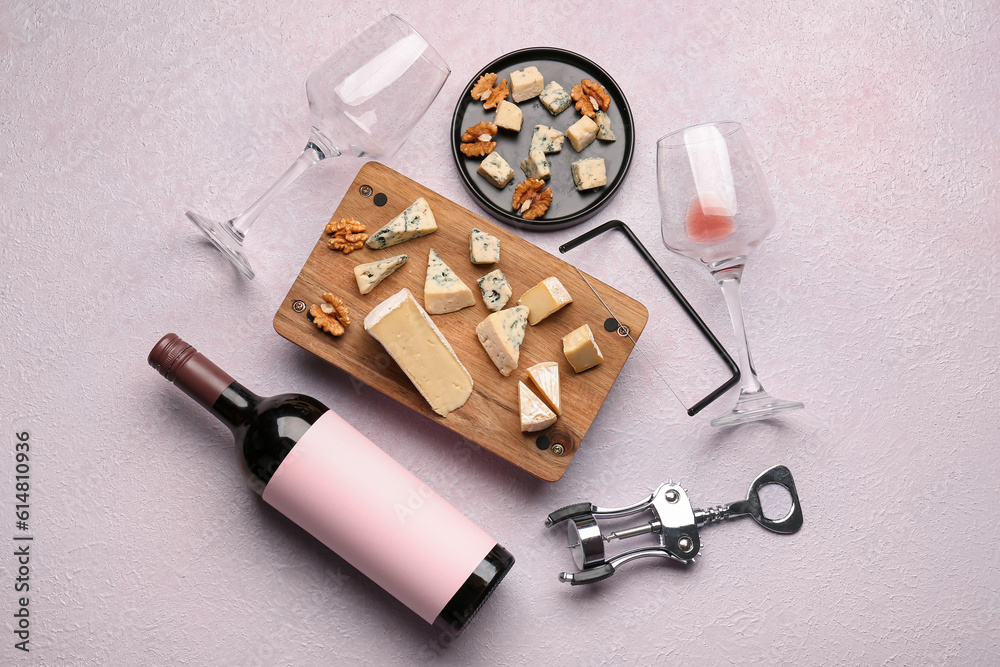 Pieces of tasty cheese, glasses and bottle with wine on light background