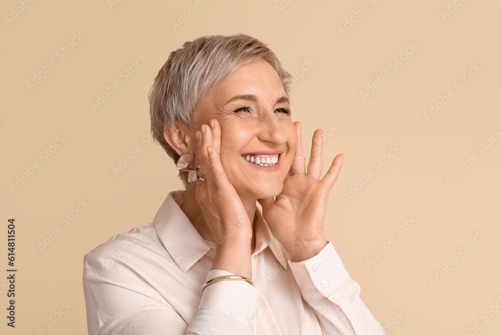 Mature blonde woman on beige background, closeup