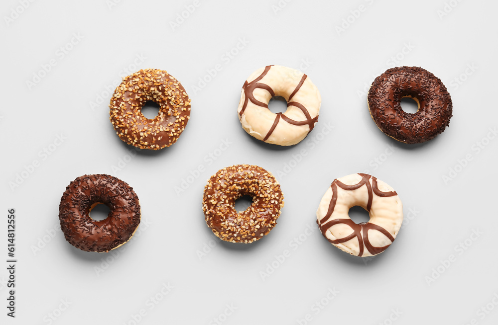 Sweet chocolate donuts on grey background