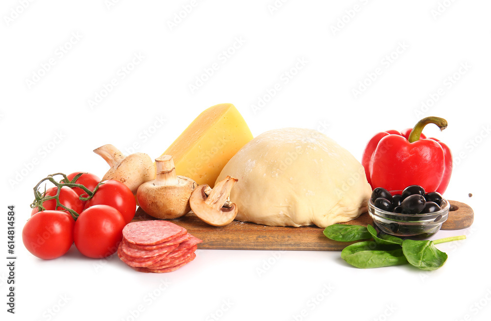 Wooden board with raw dough and ingredients for preparing pizza on white background