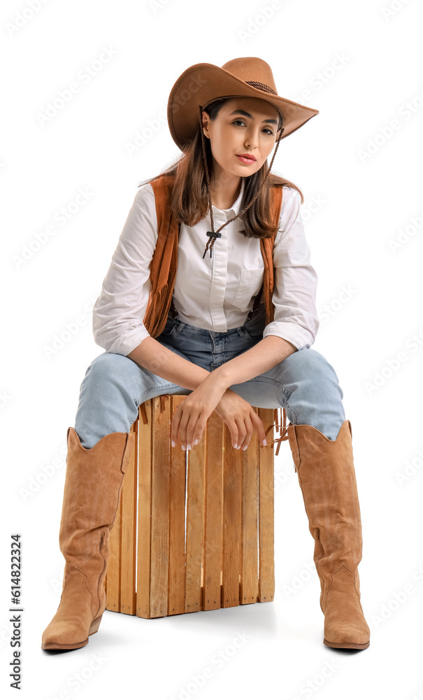 Beautiful cowgirl sitting on white background