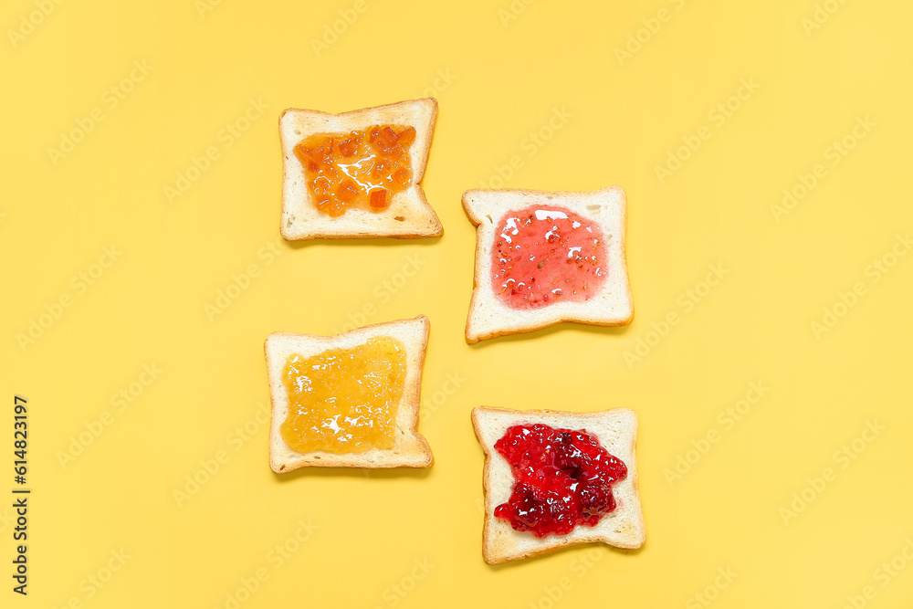 Delicious toasts with different jams on color background