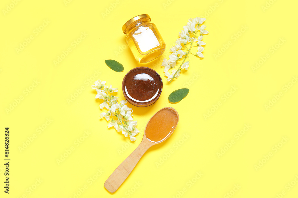 Composition with sweet honey and acacia flowers on yellow background