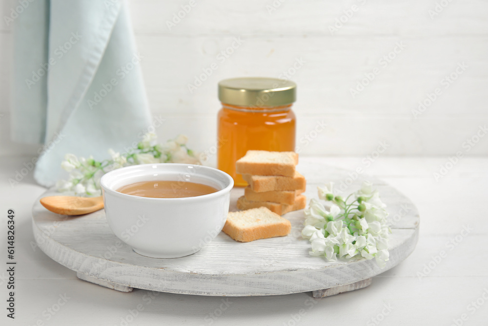 Composition with sweet honey, acacia flowers and crackers on light background, closeup