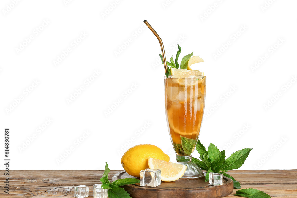 Glass of ice tea with lemon and mint on wooden table against white background