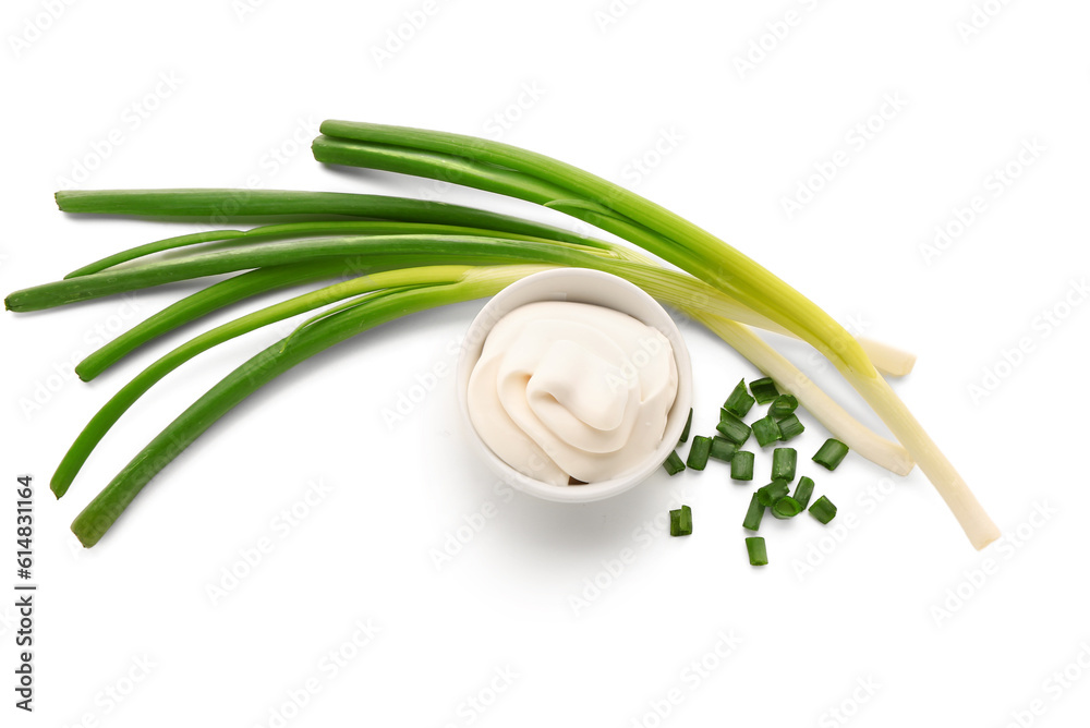 Bowl of tasty sour cream with sliced green onion on white background