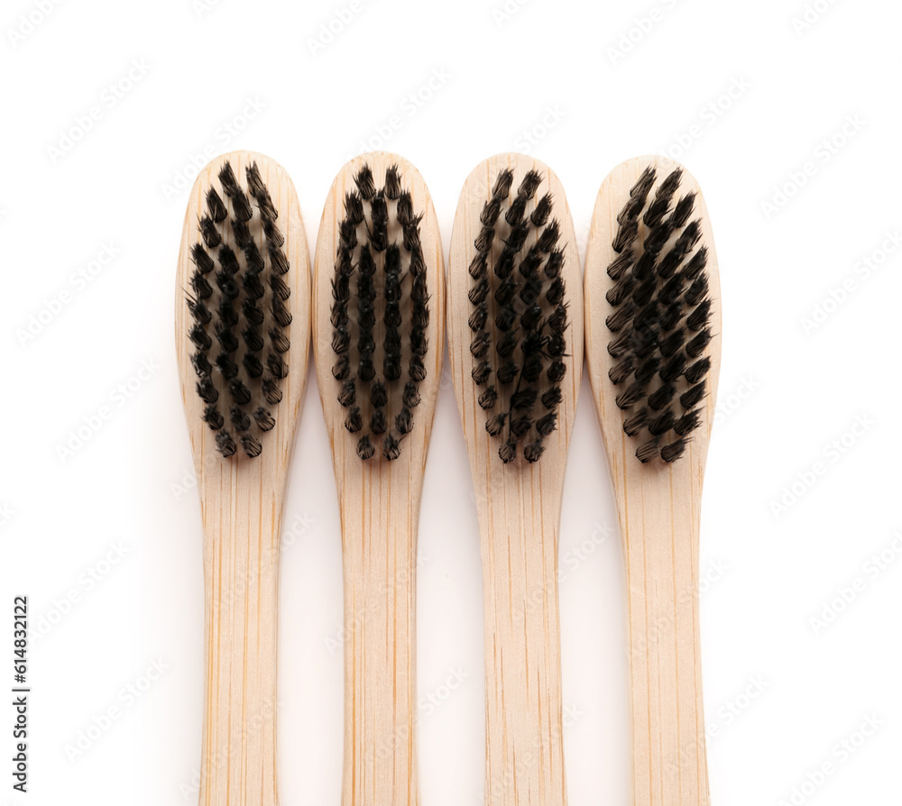 Many bamboo toothbrushes on white background