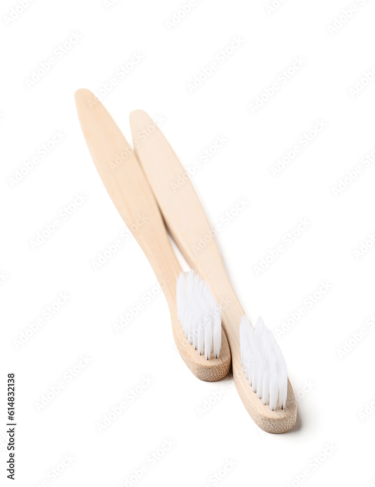 Bamboo toothbrushes on white background