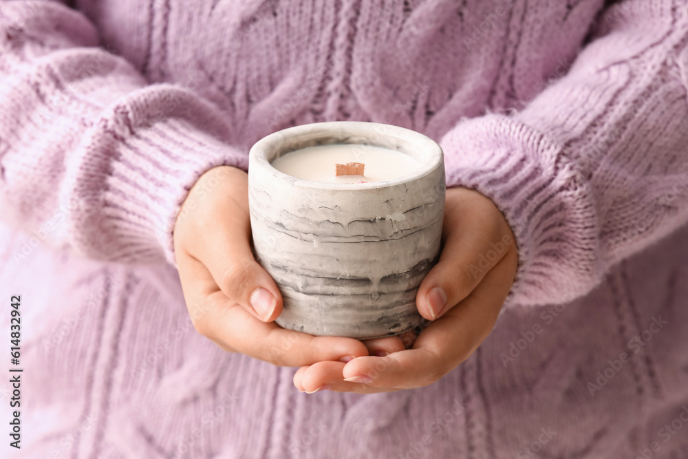 Young woman holding candle, closeup