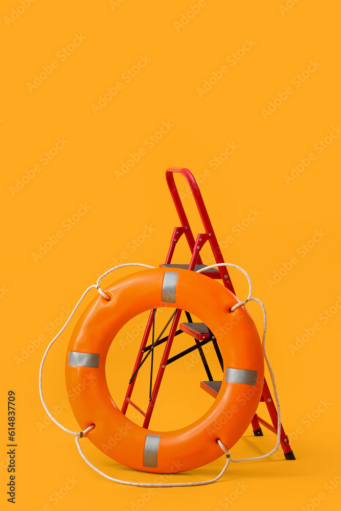 Ring buoy with ladder on yellow background