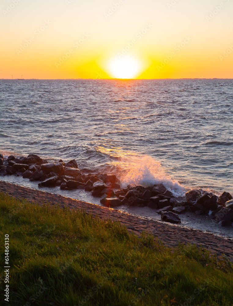 Sea sunset with waves hitting the seashore