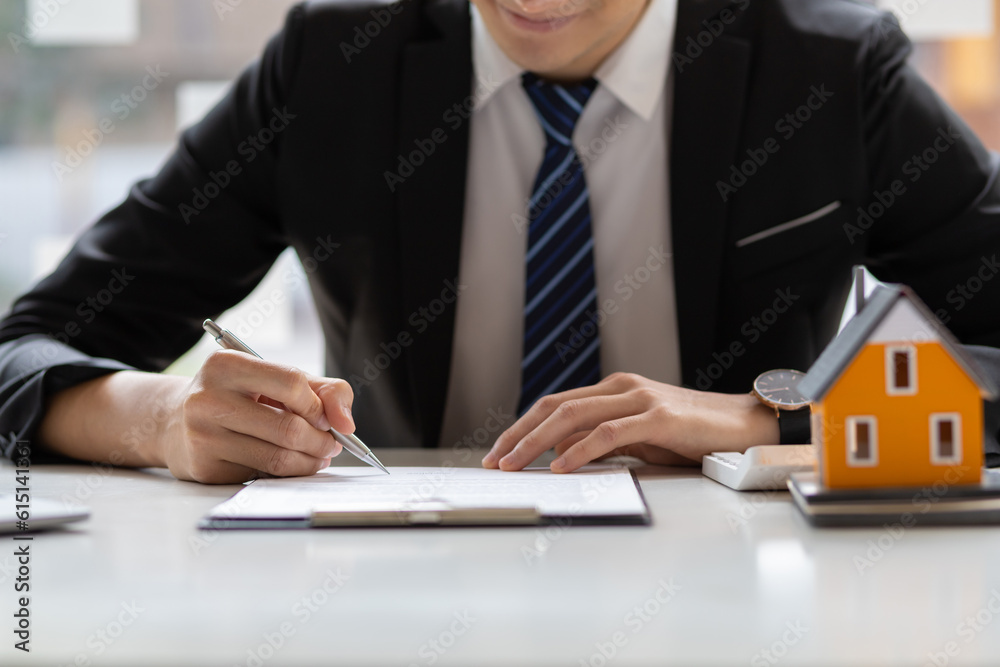 Businessman or real estate agent signs a contract to sell the house legally. Real estate consultant,