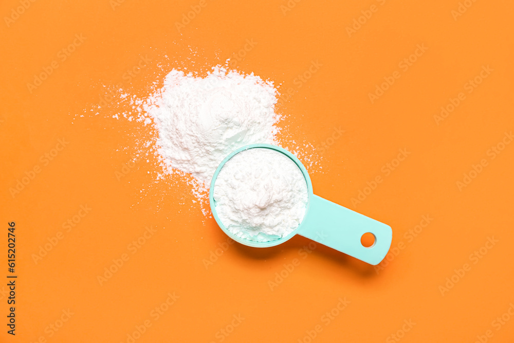 Scoop of amino acid supplement on color background