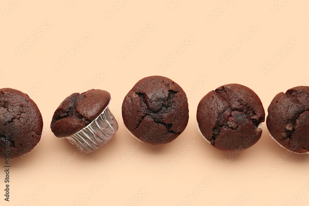 Tasty chocolate cupcakes on beige background