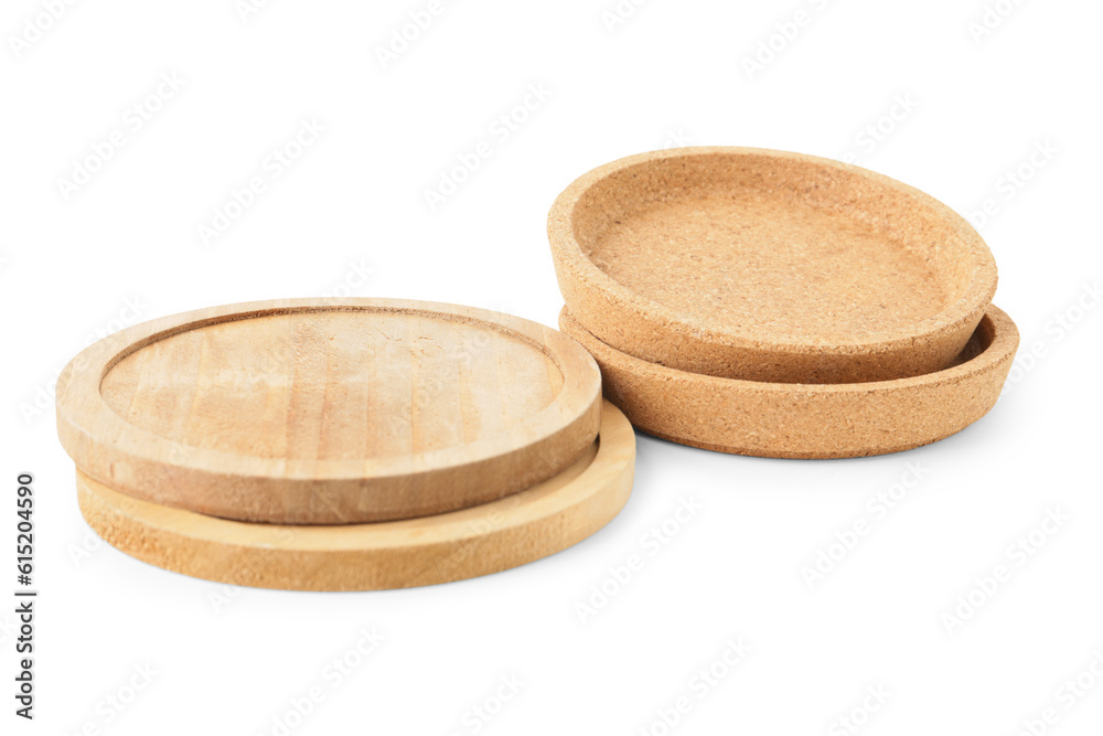 Wooden kitchen boards and cork plates on white background