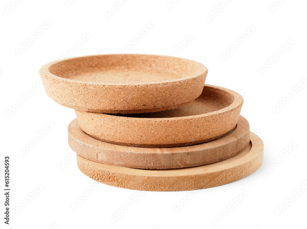 Wooden kitchen boards and cork plates on white background