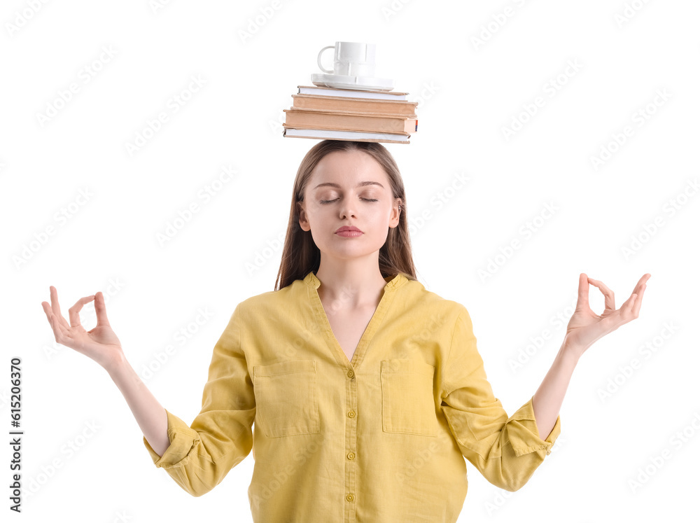 Young woman with cup and books meditating on white background. Balance concept