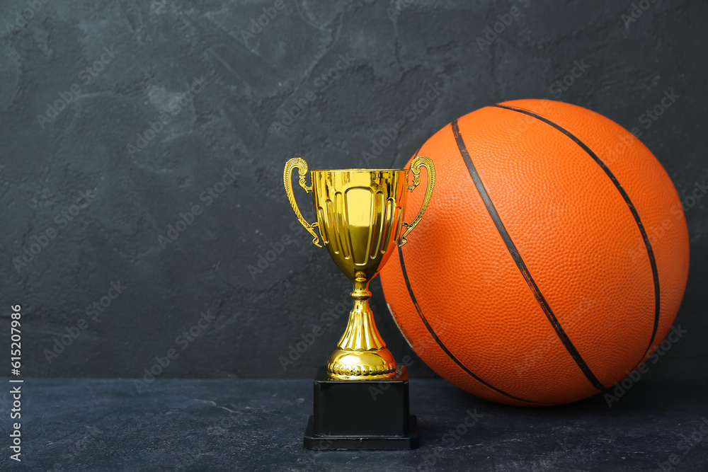 Gold cup with ball on dark background