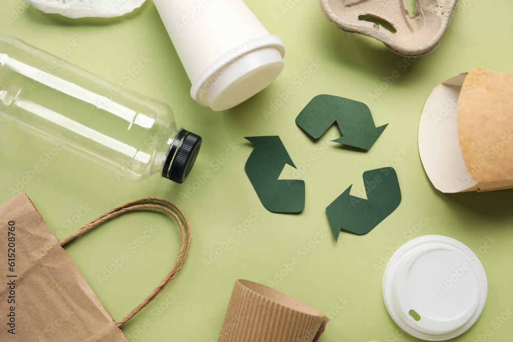 Recycling sign with garbage on green background