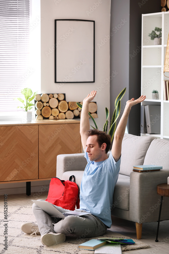 Male student resting after doing lessons at home