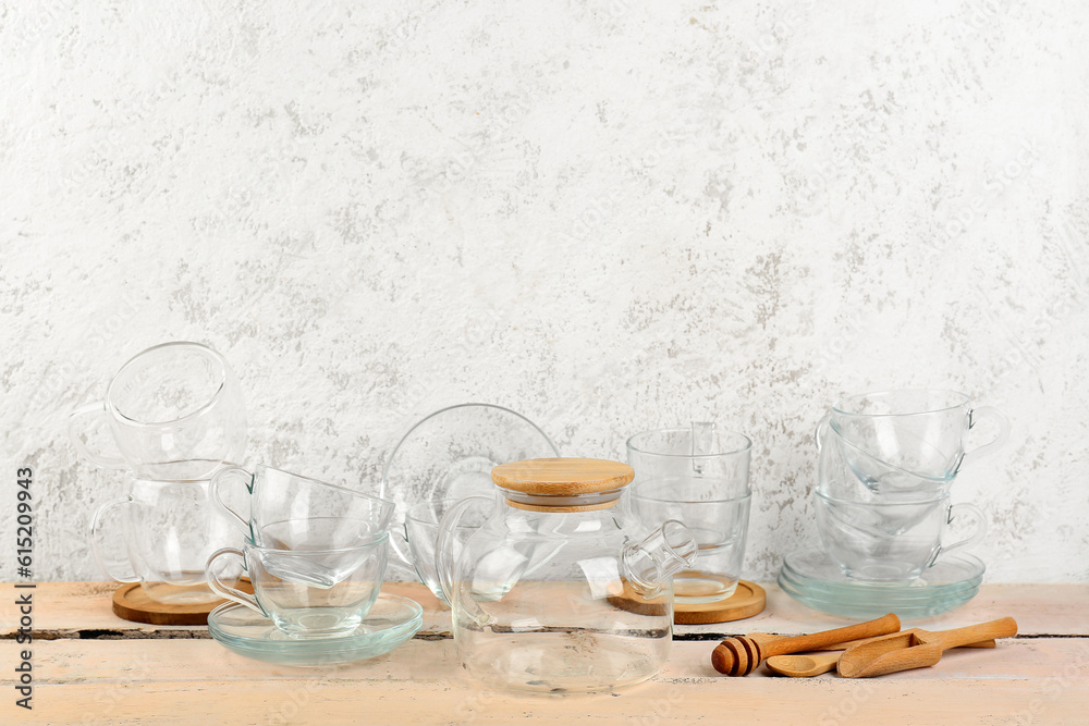 Stylish glass tea set on white wooden table