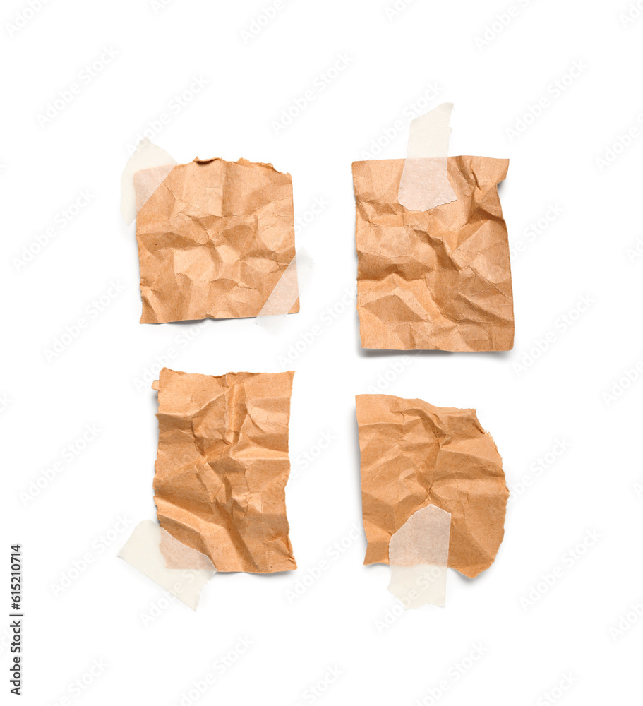 Attached pieces of creased paper sheets isolated on white background