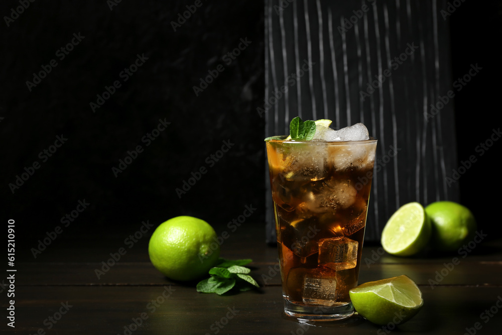 Glass of tasty Cuba Libre cocktail on table