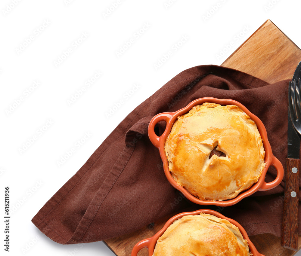 Wooden board with tasty meat pot pies on white background