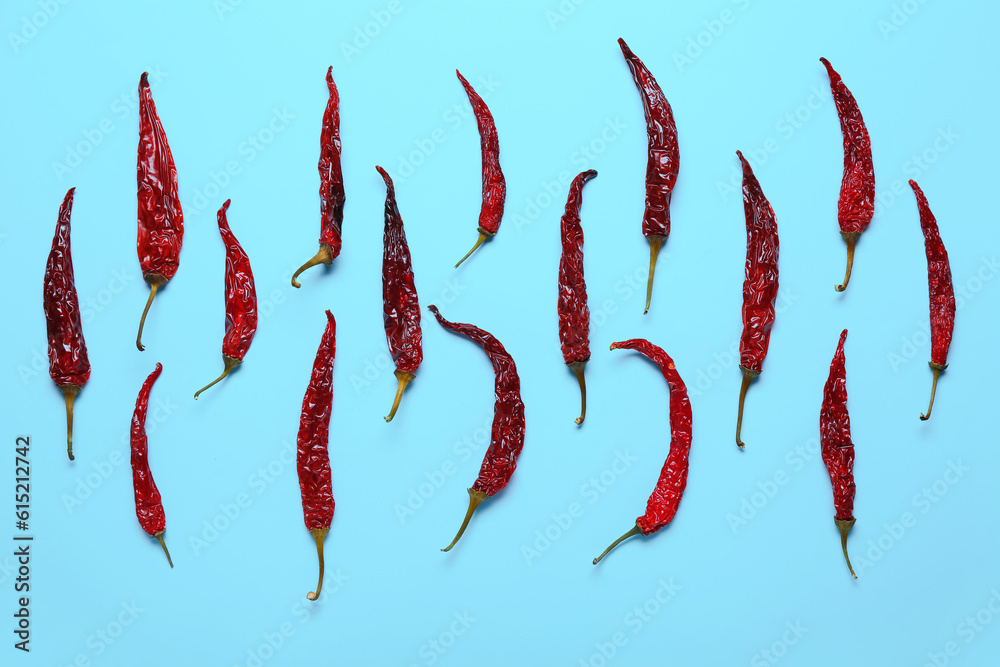 Dry hot chili peppers on blue background