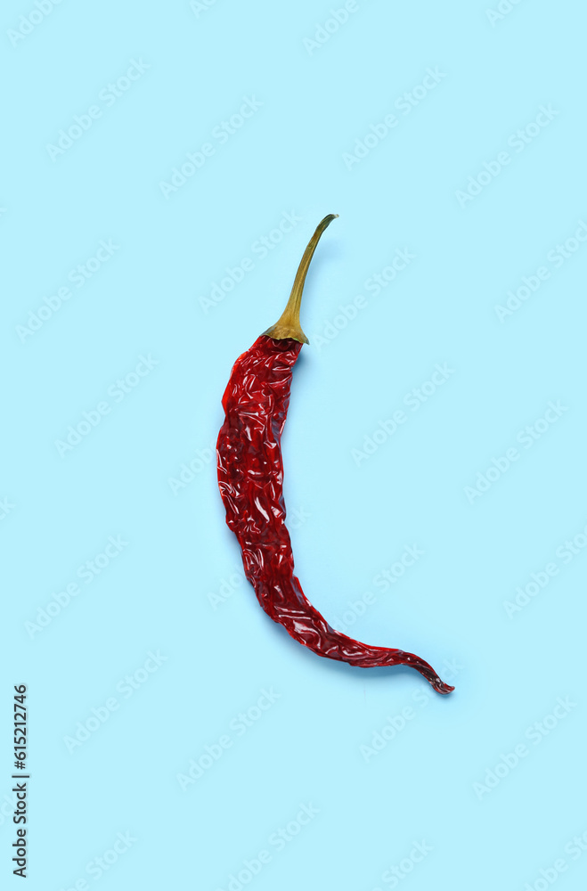 Dry hot chili pepper on blue background