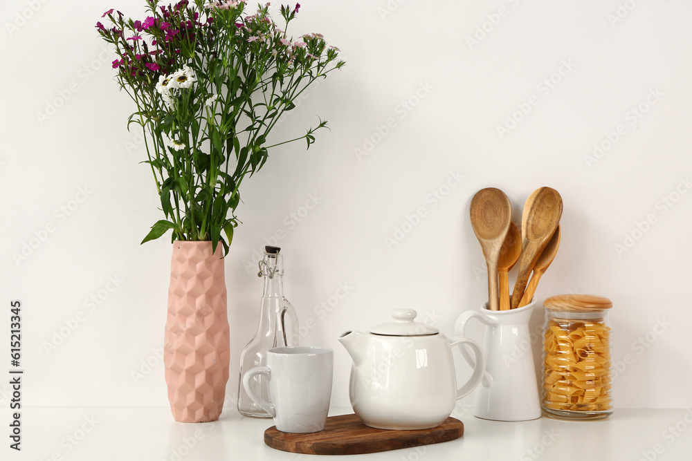 Composition with beautiful tea set and different items on white table