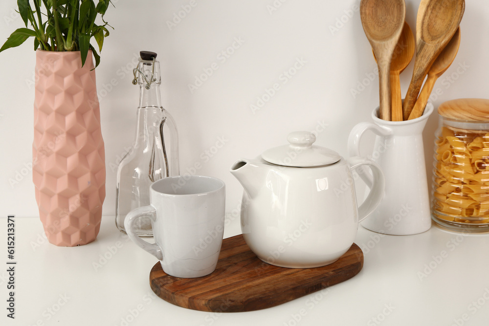 Composition with beautiful tea set and different items on white table