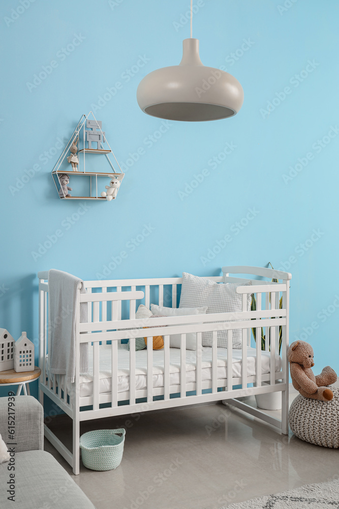 Baby crib in interior of stylish bedroom