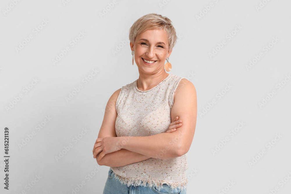 Mature blonde woman on light background