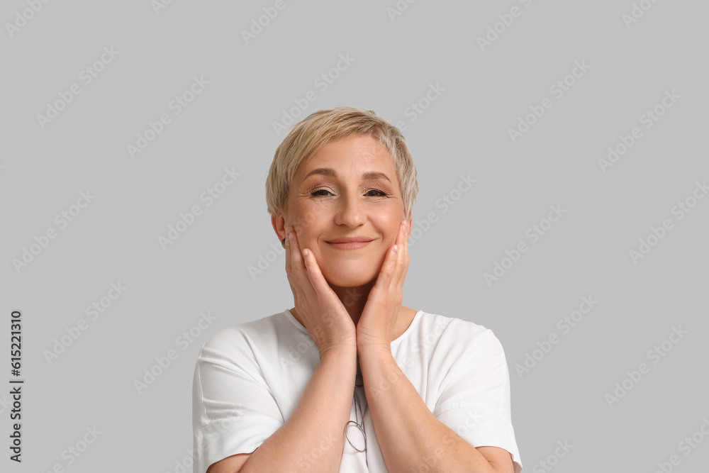 Mature blonde woman on light background, closeup