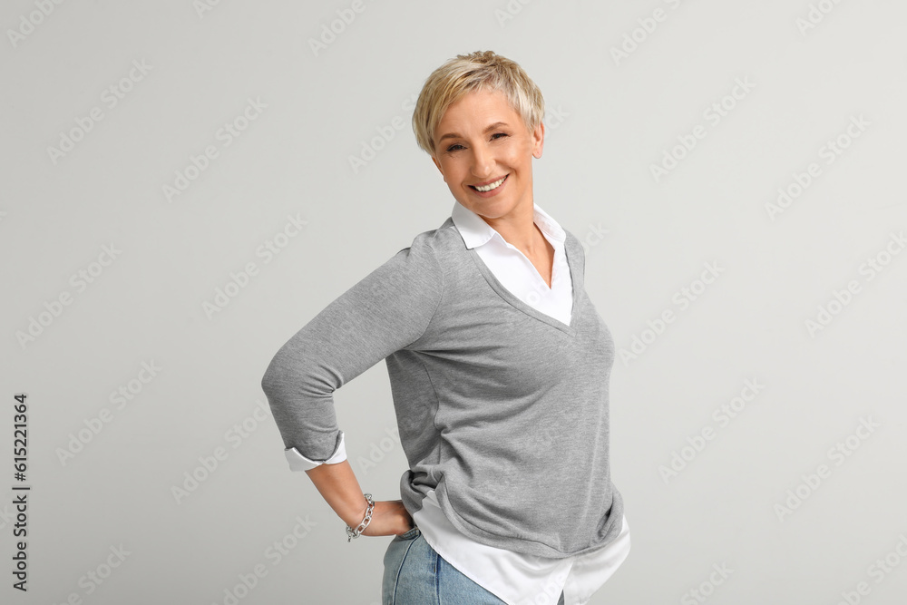 Mature blonde woman on light background