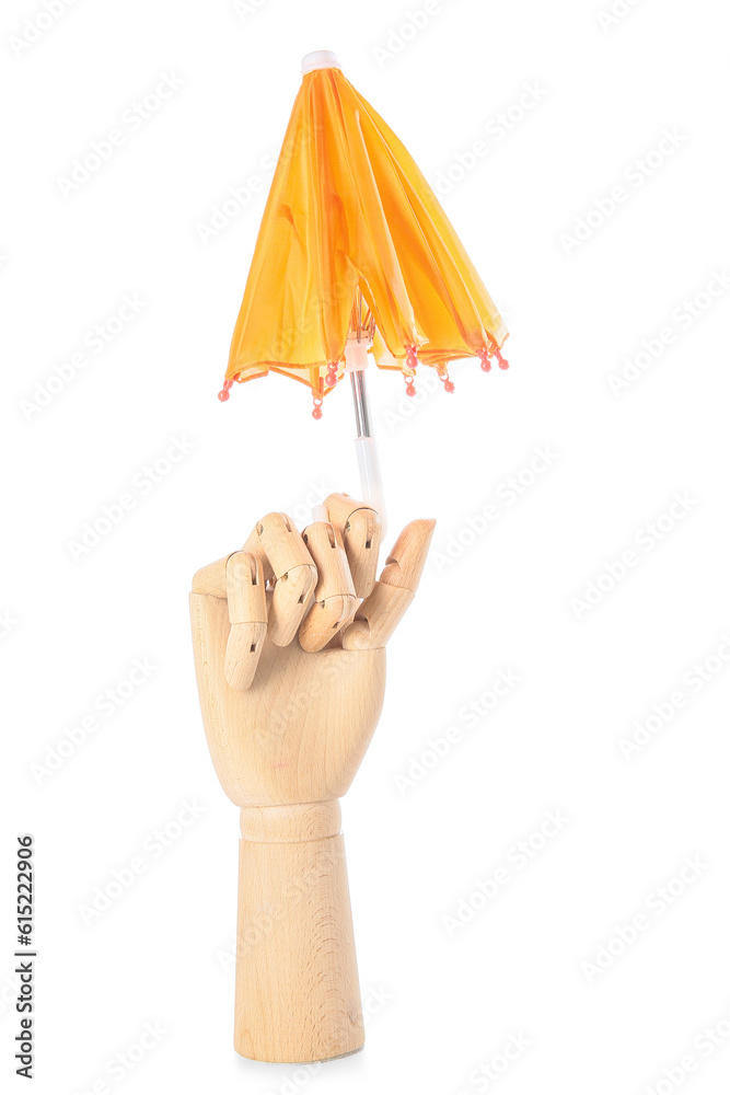 Creative composition with wooden hand and mini umbrella on white background