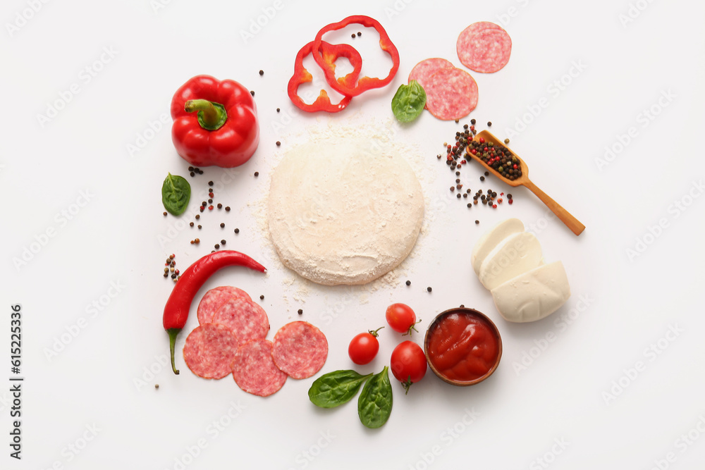 Raw dough and ingredients for preparing pizza on white background