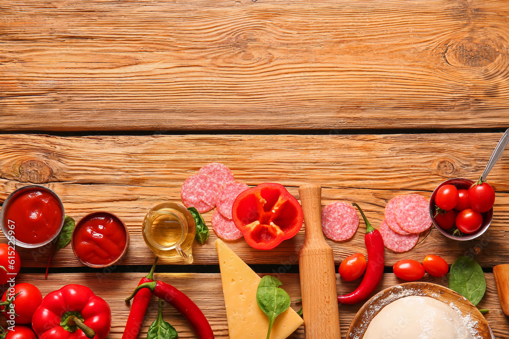 Different ingredients for preparing pizza on wooden background