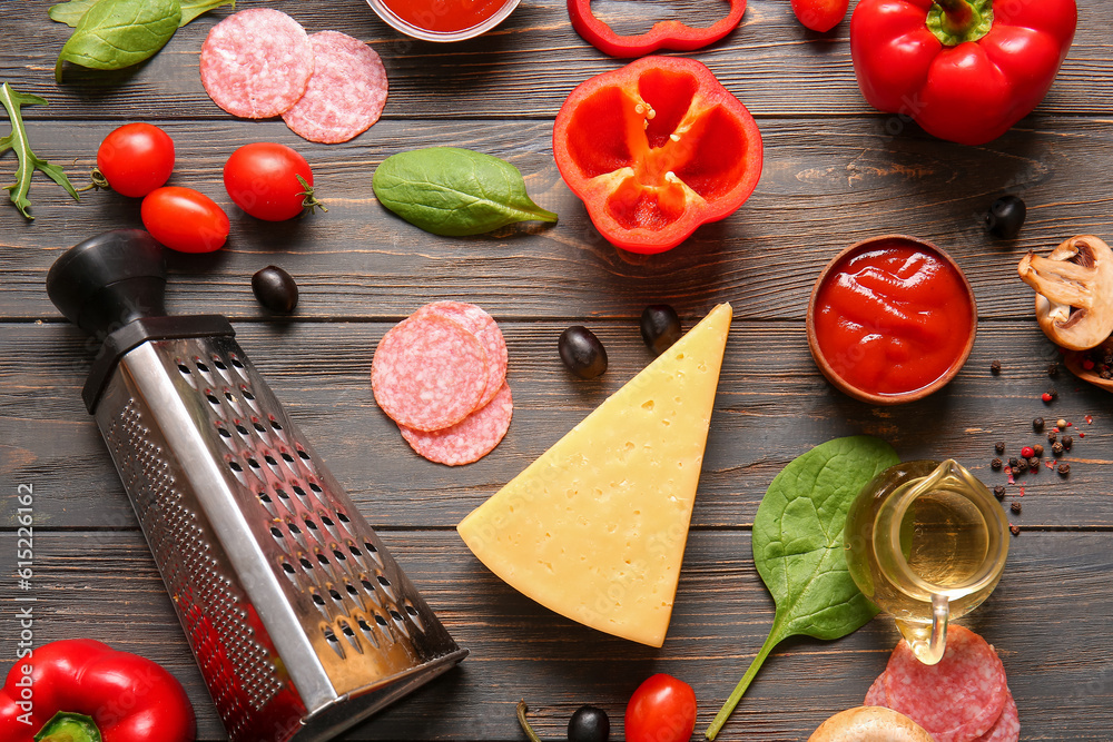 Different ingredients for preparing pizza on wooden background