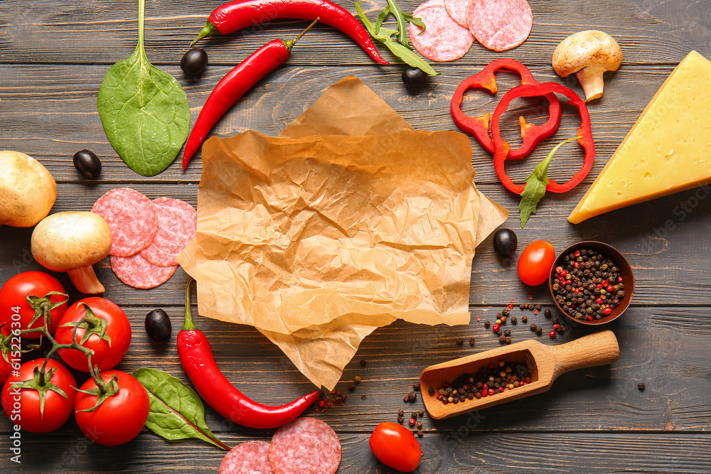 Different ingredients for preparing pizza on wooden background